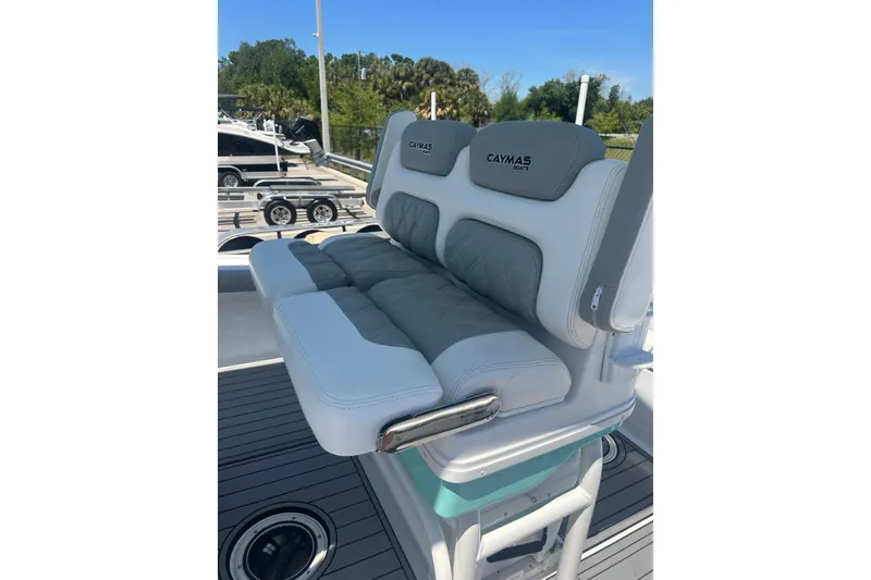 Slide: The Image of Caymas 28 HB 2021 boat seating with gray and white cushioned design. - 10