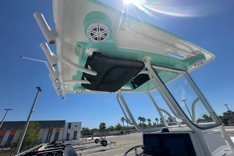 Slide: The Image of 2021 Caymas 28 HB boat with T-top and speakers under clear blue sky. - 12