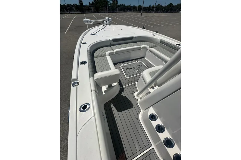 Slide: The Image of 2021 Caymas 28 HB boat interior with cushioned seating and deck details. - 14