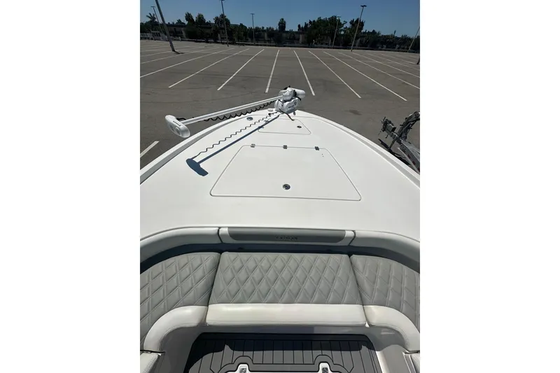 Slide: The Image of 2021 Caymas 28 HB boat in parking lot, featuring sleek design and spacious deck. - 15
