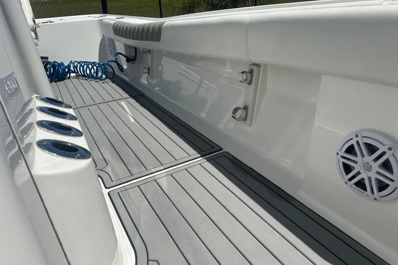 Slide: The Image of 2021 Caymas 28 HB boat interior with rod holders and marine speaker. - 19