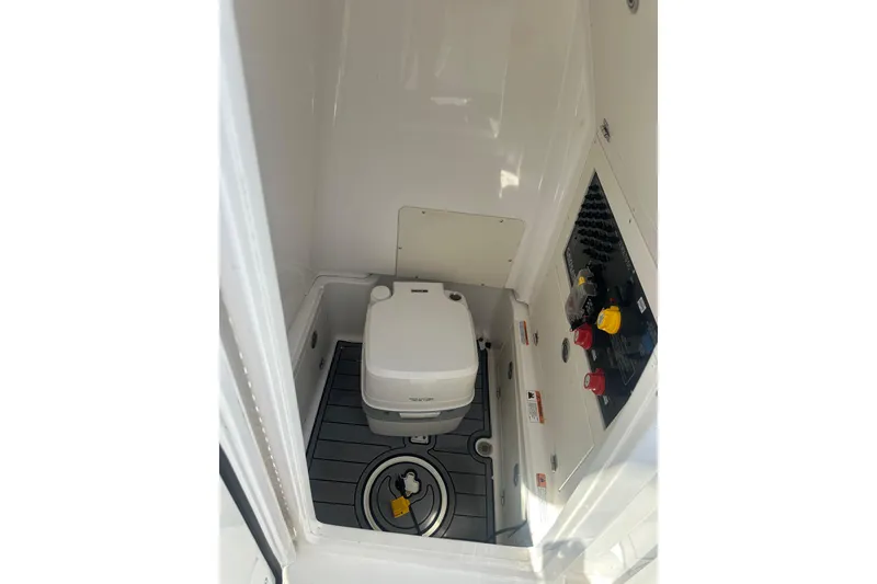 Slide: The Image of 2021 Caymas 28 HB boat interior with compact toilet and control panel. - 24
