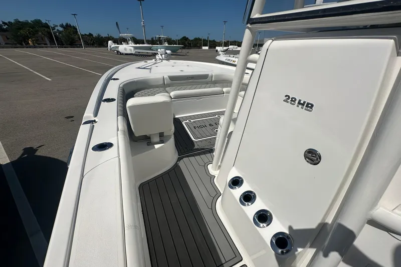 Slide: The Image of 2021 Caymas 28 HB boat interior with seating and deck details. - 28