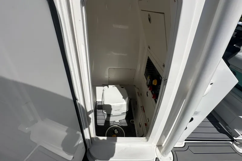 Slide: The Image of 2021 Caymas 28 HB boat interior with compact marine toilet. - 29