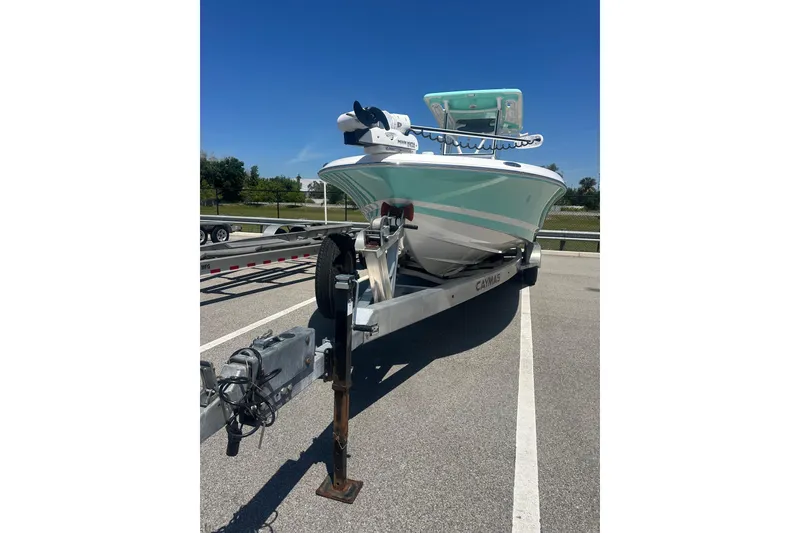 Slide: The Image of 2021 Caymas 28 HB boat on trailer, parked in sunny outdoor setting. - 3