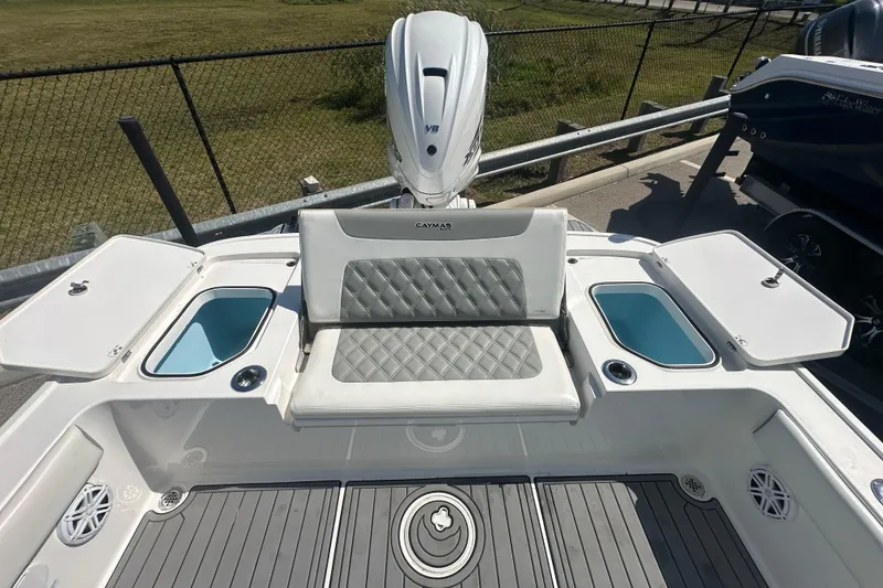 Slide: The Image of 2021 Caymas 28 HB boat interior with cushioned seating and storage compartments. - 31