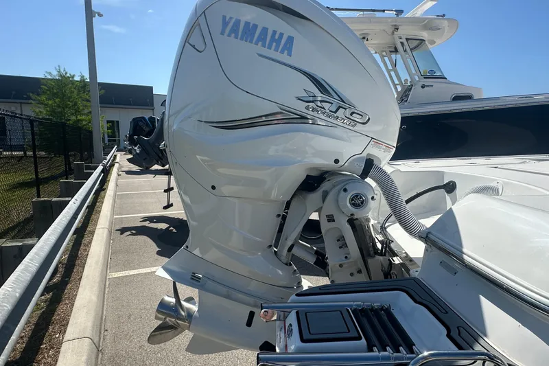 Slide: The Image of 2021 Caymas 28 HB boat with Yamaha XTO Offshore engine in a parking lot. - 32