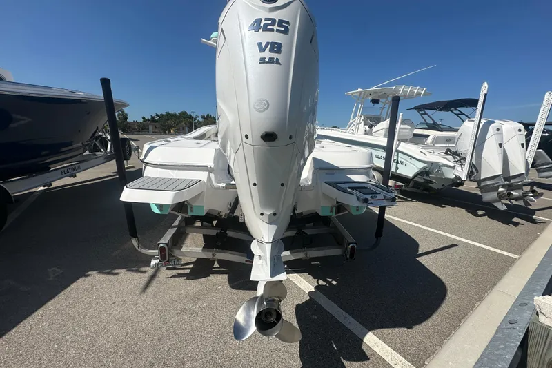 Slide: The Image of 2021 Caymas 28 HB boat with powerful 425 V8 engine, parked in a marina. - 34