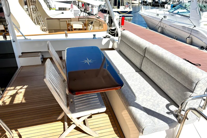 Slide: The Image of 2001 Pacific Mariner 65 Motoryacht cruising on clear turquoise waters. - 2