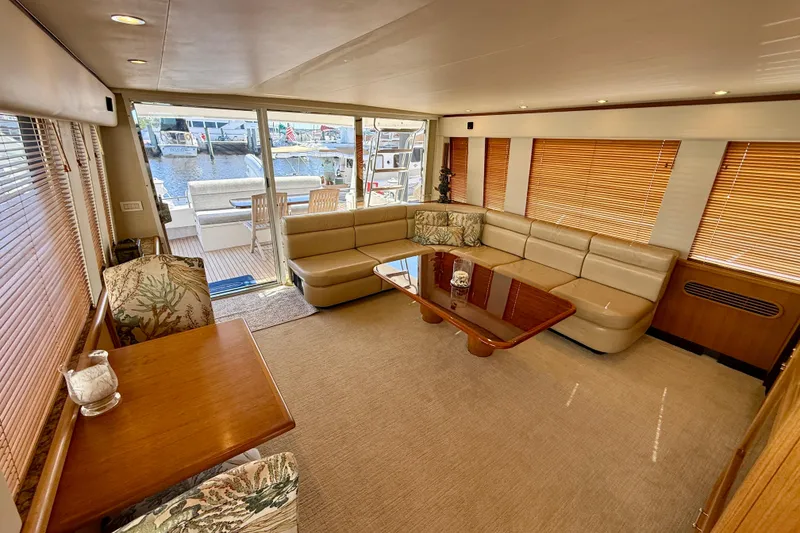 Slide: The Image of 2001 Pacific Mariner 65 Motoryacht docked in clear blue water under a sunny sky. - 4