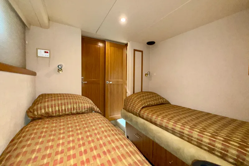 Slide: The Image of Twin cabin with striped bedding in 2001 Pacific Mariner 65 Motoryacht. - 42