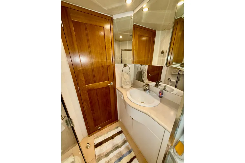 Slide: The Image of Luxurious bathroom in 2001 Pacific Mariner 65 Motoryacht with wooden door and modern fixtures. - 44