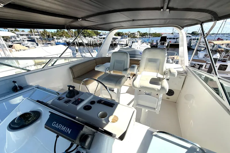 Slide: The Image of Flybridge of 2001 Pacific Mariner 65 Motoryacht with helm chairs and Garmin navigation system. - 47