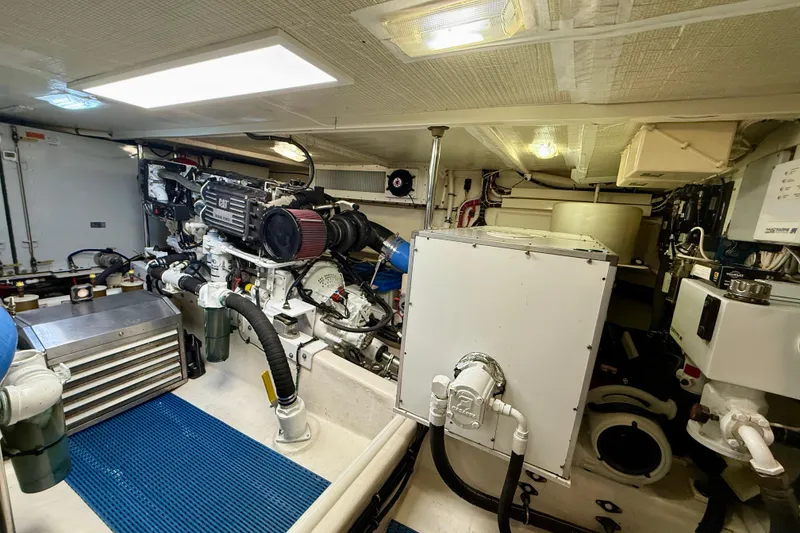 Slide: The Image of Engine room of a 2001 Pacific Mariner 65 Motoryacht, featuring mechanical components and equipment. - 54