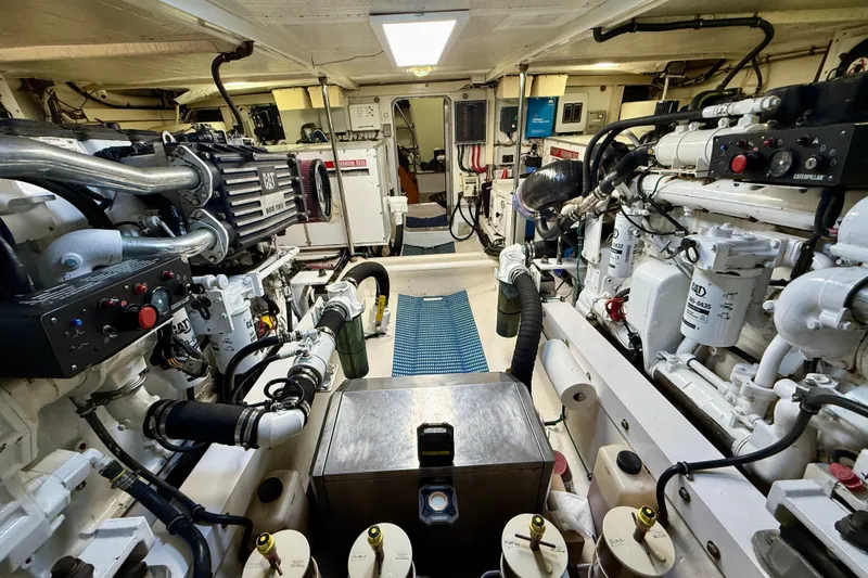 Slide: The Image of Engine room of a 2001 Pacific Mariner 65 Motoryacht, featuring Caterpillar engines and mechanical systems. - 57