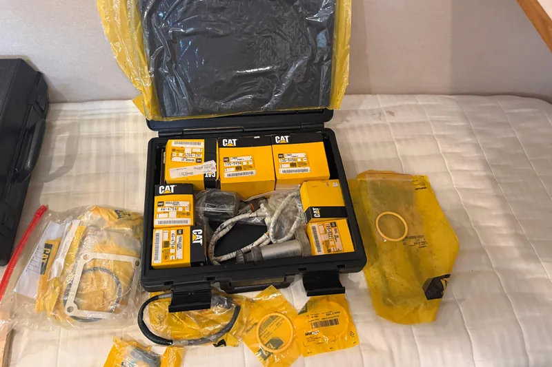 Slide: The Image of CAT parts and tools on a bed, Pacific Mariner 65 Motoryacht, 2001 model. - 61
