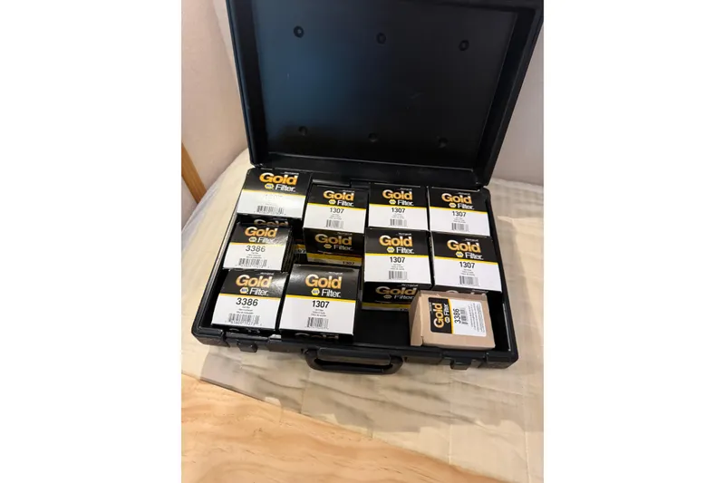 Slide: The Image of Open case with Gold oil filters for Pacific Mariner 65 Motoryacht, 2001 model. - 62