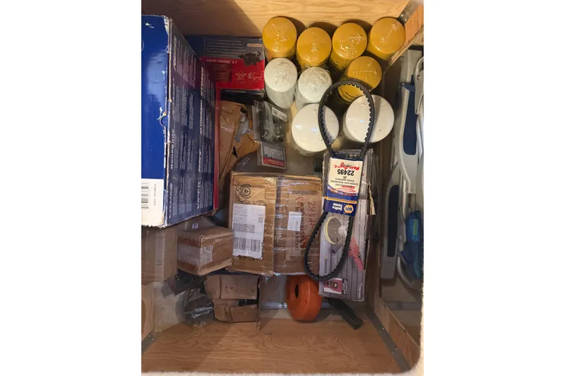 Slide: The Image of Storage compartment with various supplies and tools on a 2001 Pacific Mariner 65 Motoryacht. - 63