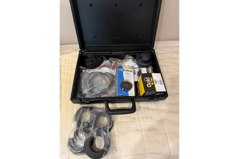 Slide: The Image of Open black case with assorted marine parts for 2001 Pacific Mariner 65 Motoryacht. - 64