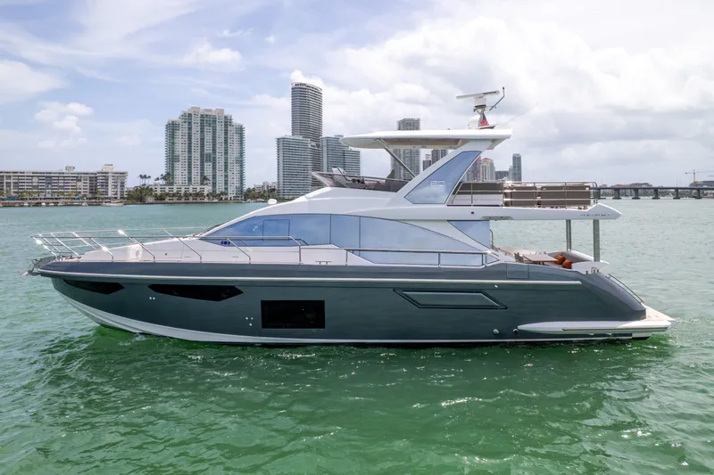 Slide: The Image of Azimut 60 Fly 2023 yacht against urban skyline. - 2