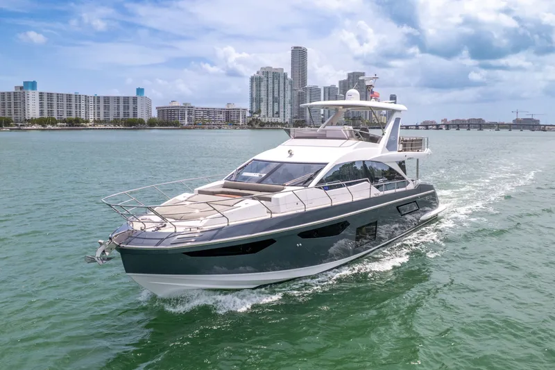 Slide: The Image of Azimut 60 Fly 2023 yacht cruising on water with city skyline. - 3