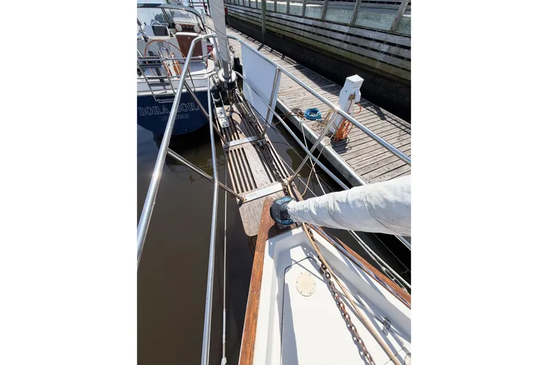 Slide: The Image of 1987 Bayfield 36 sailboat docked, showing deck and rigging details. - 10
