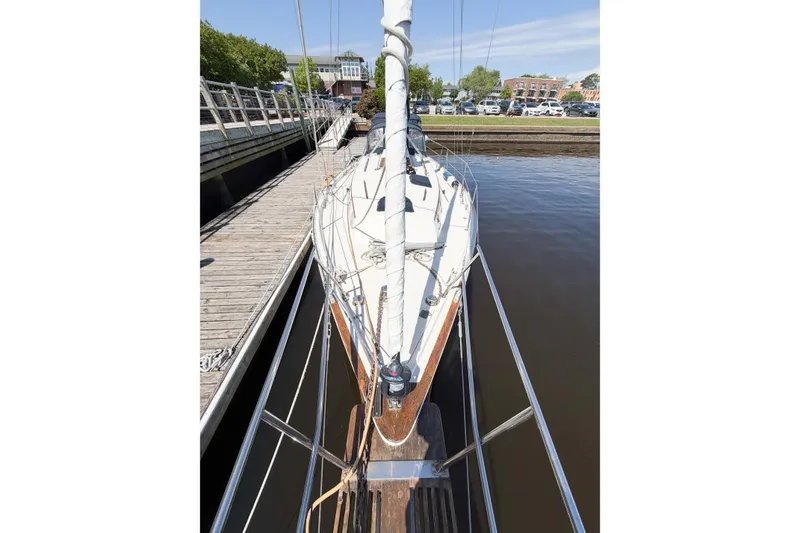 Slide: The Image of 1987 Bayfield 36 sailboat docked at a marina, viewed from the bow. - 11