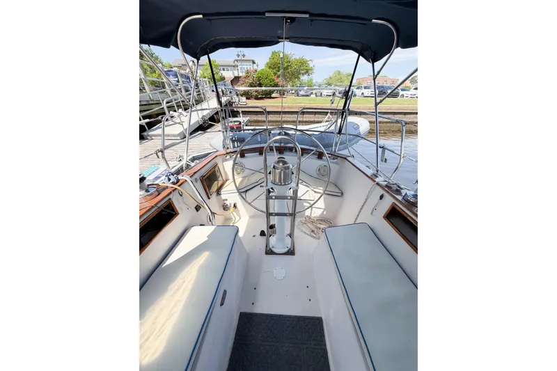 Slide: The Image of Cockpit of a 1987 Bayfield 36 sailboat with steering wheel and seating. - 14