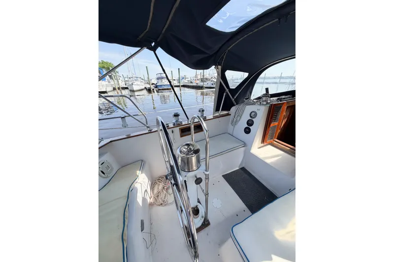 Slide: The Image of Cockpit of a 1987 Bayfield 36 sailboat with marina view. - 17