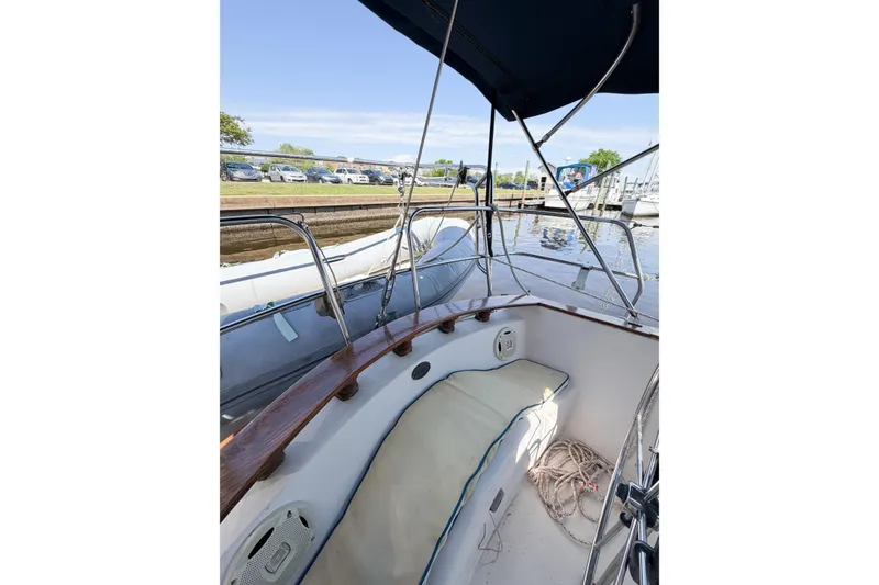 Slide: The Image of 1987 Bayfield 36 sailboat cockpit with seating, docked near a marina. - 18