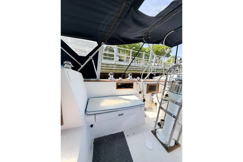 Slide: The Image of 1987 Bayfield 36 sailboat cockpit with seating, helm, and canopy. - 19