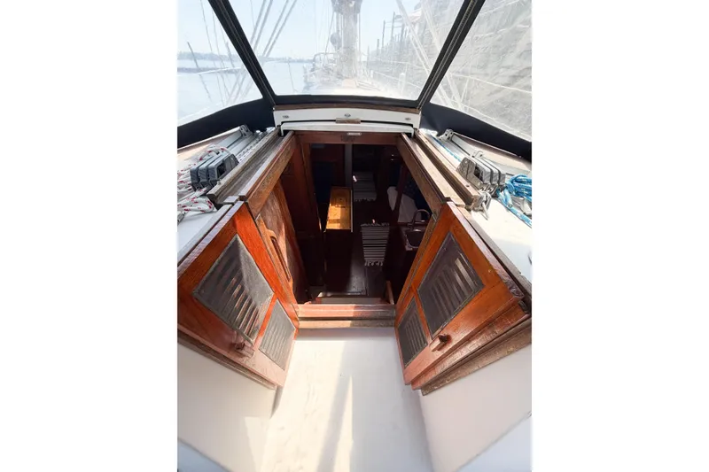 Slide: The Image of Interior view of 1987 Bayfield 36 sailboat cabin entrance with wooden doors. - 24