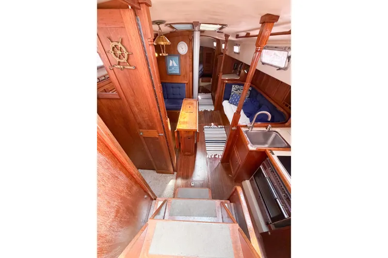 Slide: The Image of Interior of a 1987 Bayfield 36 sailboat with wooden finishes and cozy seating. - 25