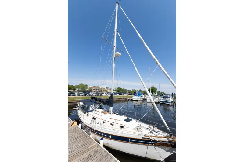 Slide: The Image of 1987 Bayfield 36 sailboat docked at marina under clear blue sky. - 3