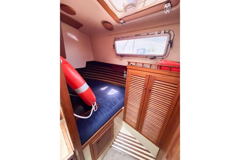 Slide: The Image of Cozy cabin interior of 1987 Bayfield 36 sailboat with wooden cabinetry and nautical decor. - 30
