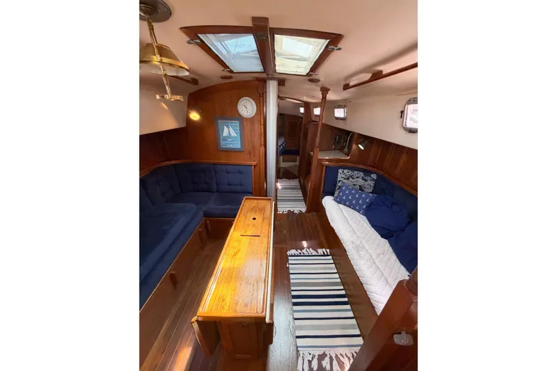 Slide: The Image of Interior of a 1987 Bayfield 36 sailboat with cozy seating and nautical decor. - 33