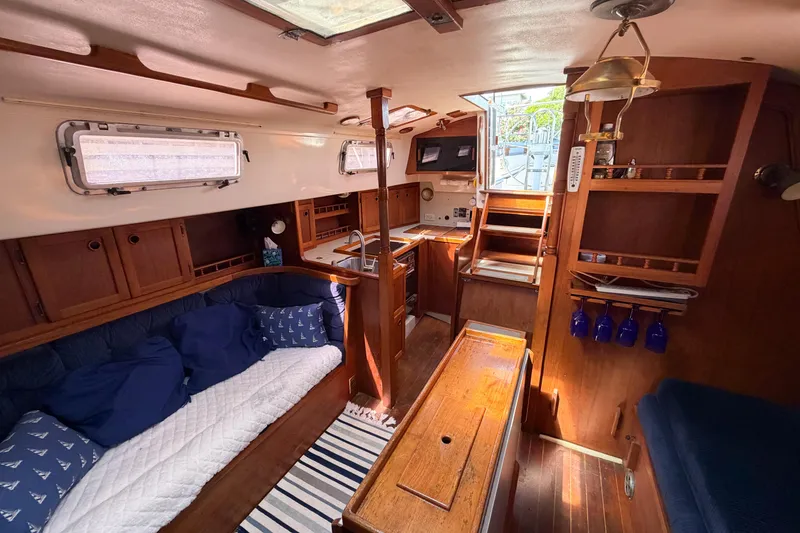 Slide: The Image of Interior of a 1987 Bayfield 36 sailboat with cozy seating and wooden cabinetry. - 37