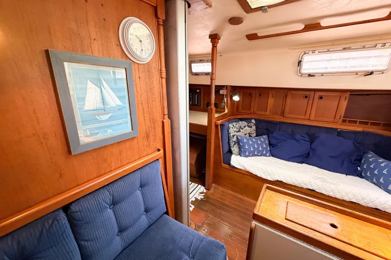 Slide: The Image of Interior of 1987 Bayfield 36 sailboat with cozy seating and nautical decor. - 38