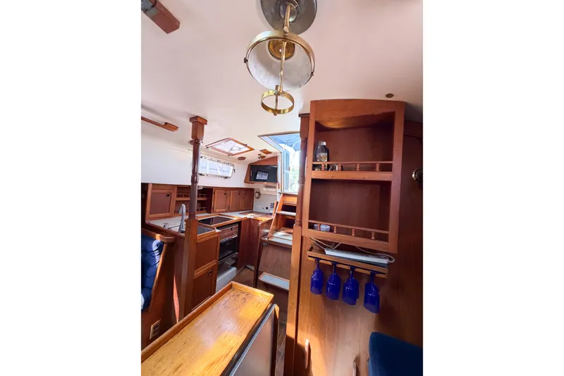 Slide: The Image of Interior of 1987 Bayfield 36 sailboat with wooden cabinetry and nautical decor. - 40