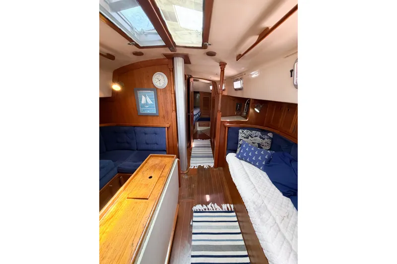 Slide: The Image of Interior of a 1987 Bayfield 36 sailboat with cozy seating and nautical decor. - 42