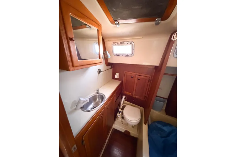 Slide: The Image of 1987 Bayfield 36 yacht bathroom with sink, mirror, and toilet. - 45