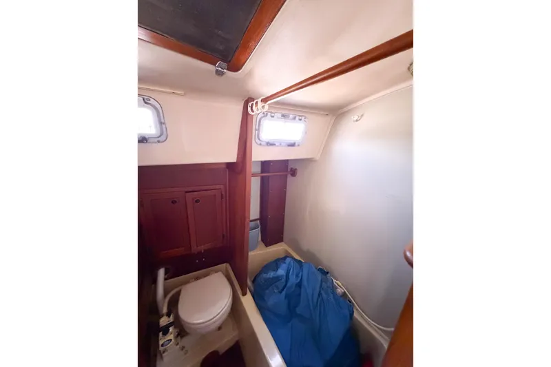 Slide: The Image of Interior of 1987 Bayfield 36 sailboat bathroom with toilet and storage cabinets. - 46