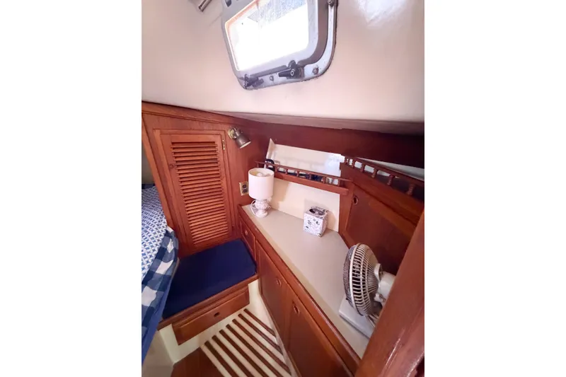 Slide: The Image of Cozy interior of 1987 Bayfield 36 sailboat with wooden cabinetry and nautical decor. - 53