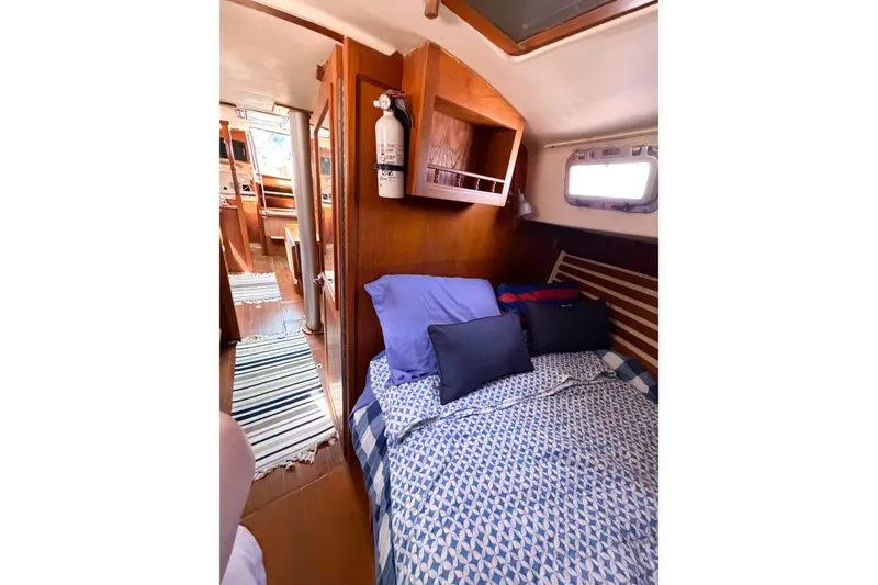 Slide: The Image of Cozy cabin interior of 1987 Bayfield 36 sailboat with bed and wooden furnishings. - 54