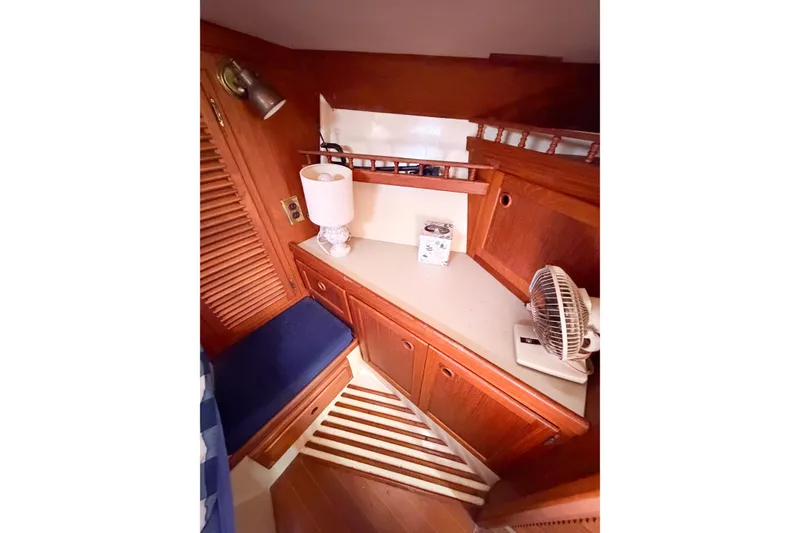 Slide: The Image of Cozy interior of 1987 Bayfield 36 sailboat with wooden cabinetry and nautical decor. - 58