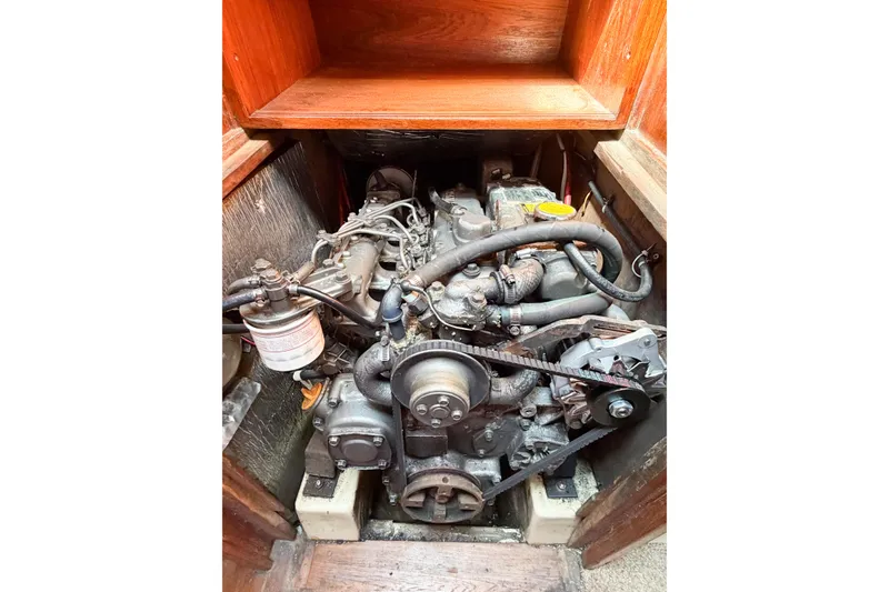 Slide: The Image of Engine compartment of a 1987 Bayfield 36 sailboat, showcasing mechanical components and belts. - 65