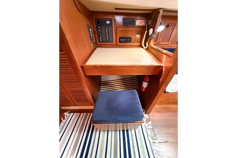 Slide: The Image of Navigation station in 1987 Bayfield 36 sailboat with control panel and seating. - 66