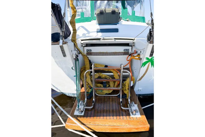 Slide: The Image of Beneteau Oceanis 42CC 2002 yacht stern with wooden deck and metal ladder. - 12