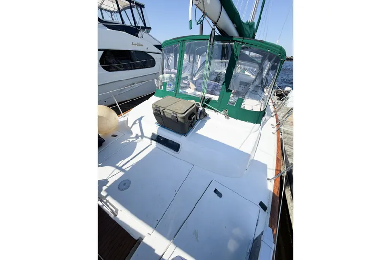 Slide: The Image of Beneteau Oceanis 42CC sailboat, 2002 model, docked with green canopy and spacious deck. - 18