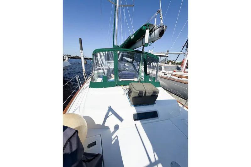Slide: The Image of 2002 Beneteau Oceanis 42CC sailboat with green canopy, docked under clear blue sky. - 20